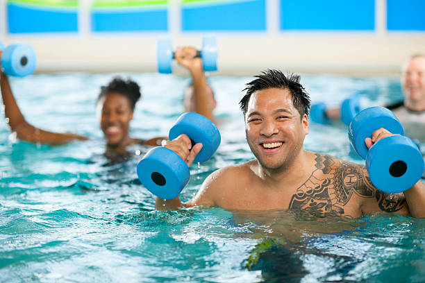 Man in water aerobics class.