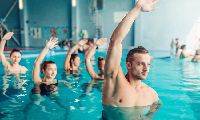 Aqua aerobics in water sport center, indoor swimming pool, recreational leisure