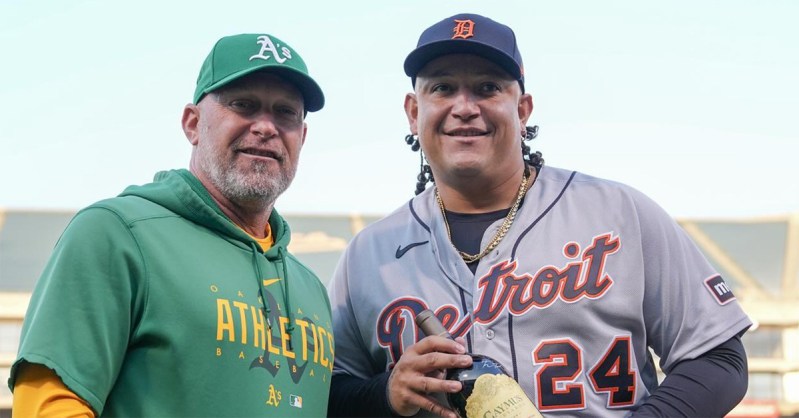 Miguel Cabrera holding the wine alongside the manager of the Oakland A's.