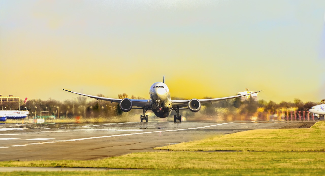 airplane taking off on a runway at sunset