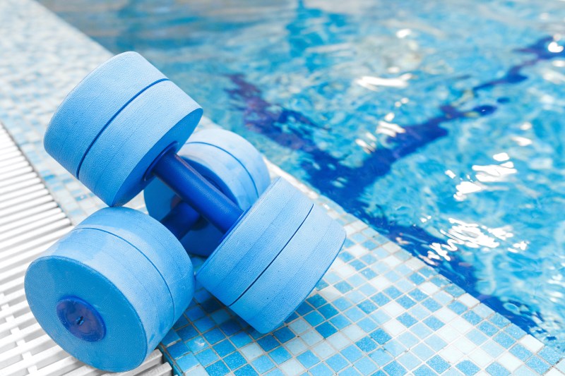 dumbbells equipment for aqua aerobics sport near swimming pool