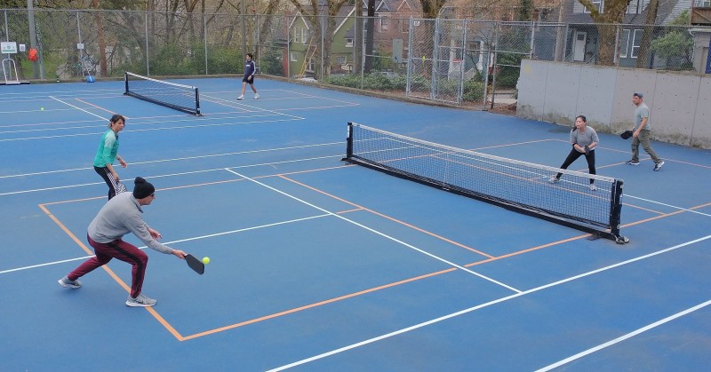People playing pickleball outside 