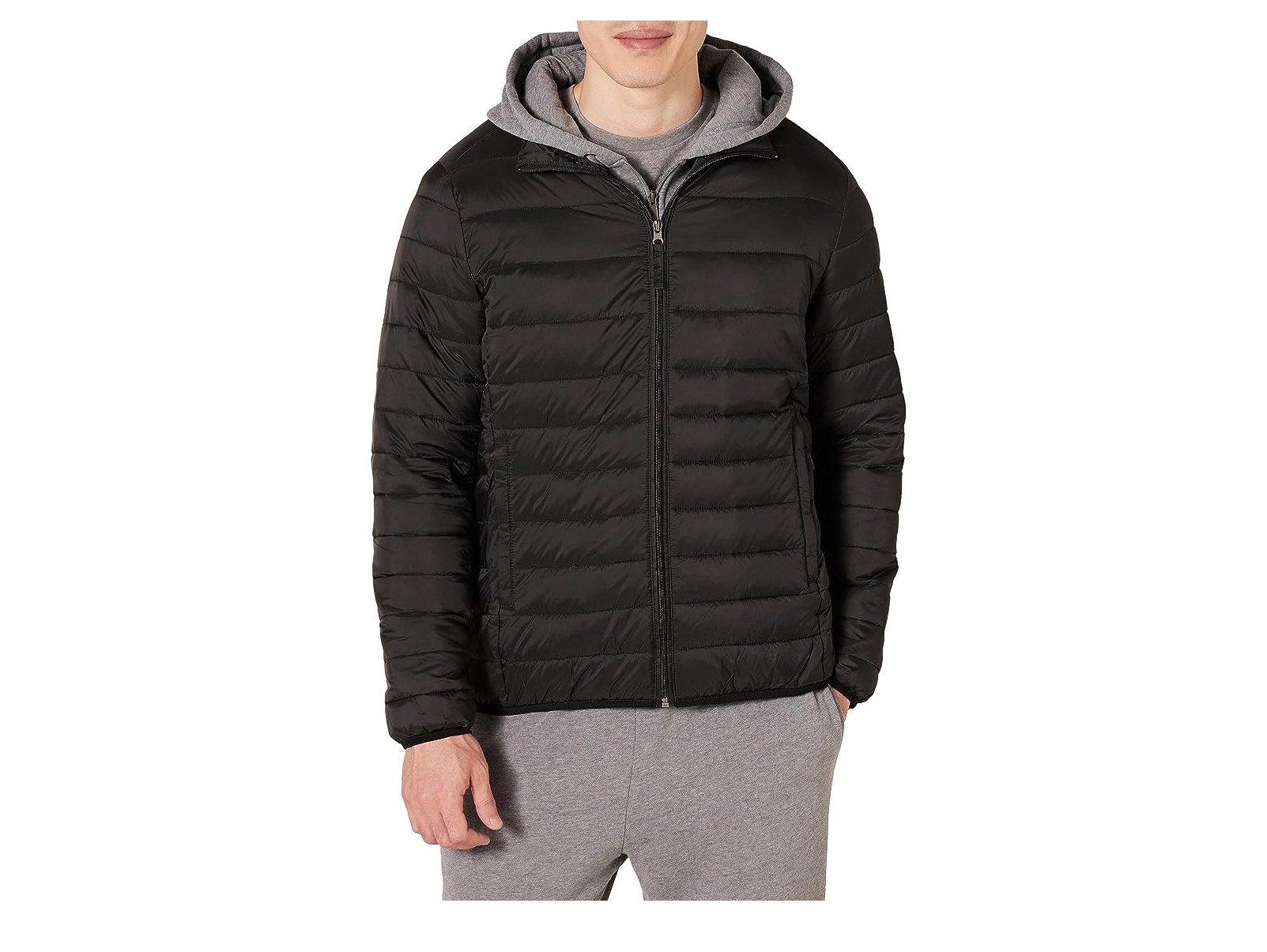 A man wearing the Amazon Essentials Men's Packable Lightweight Water-Resistant Puffer Jacket.
