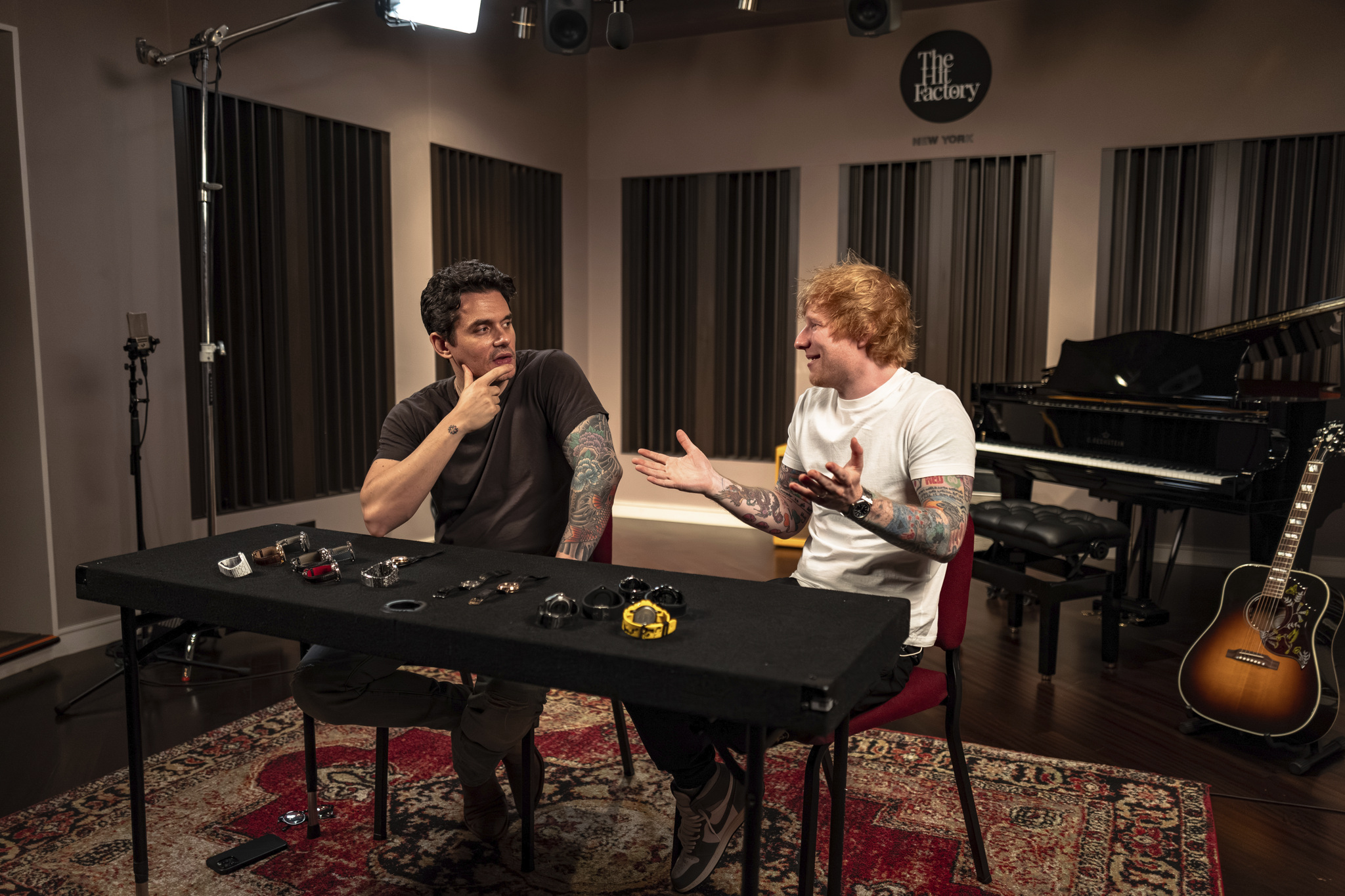 Ed Sheeran with a table full of watches