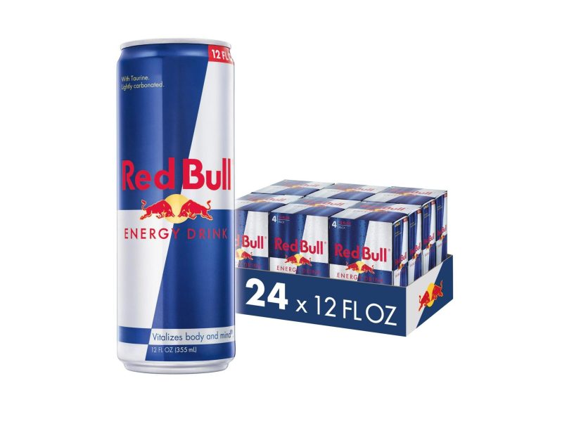 A can of Red Bull in front of a box of Red Bull cans.