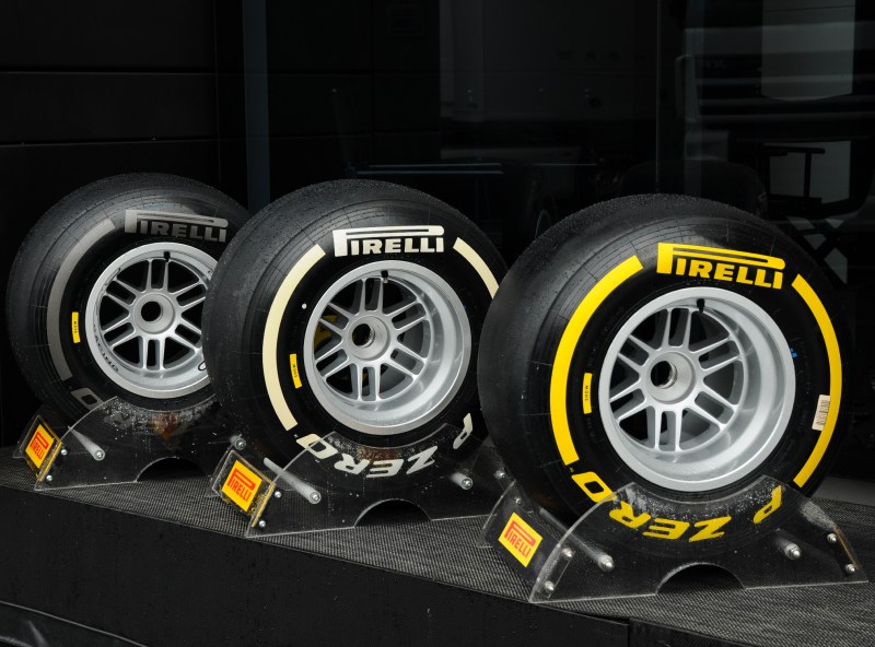 Three types of Pirelli F1 racing tires on stands.