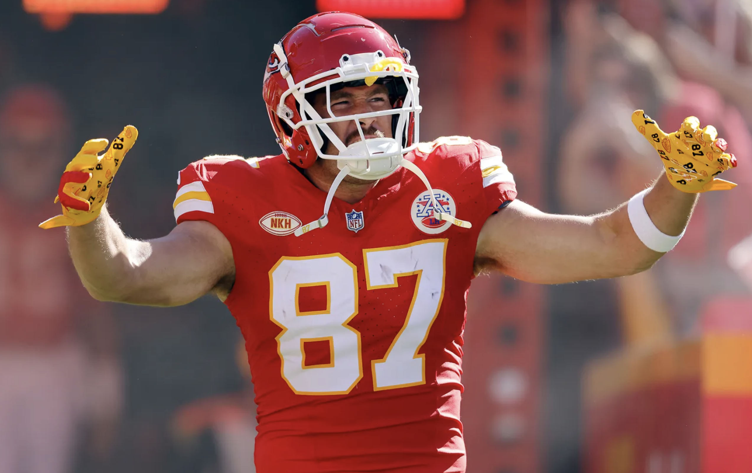 Travis Kelce on the field in his trademark Kansas City Chiefs jersey, complete with helmet.