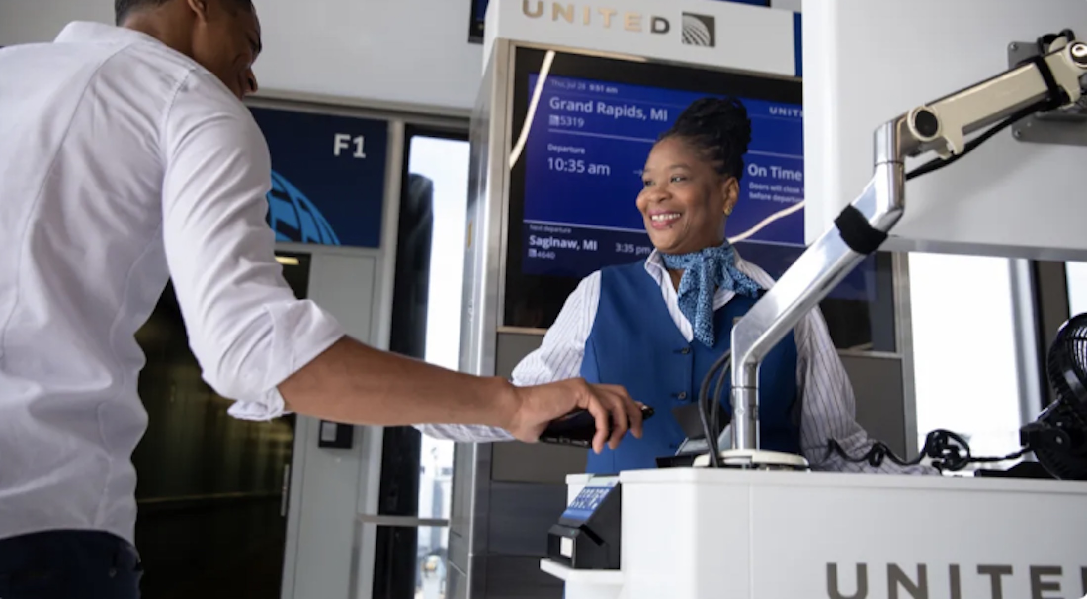 A passenger scans their boarding pass prior to boarding the plane.