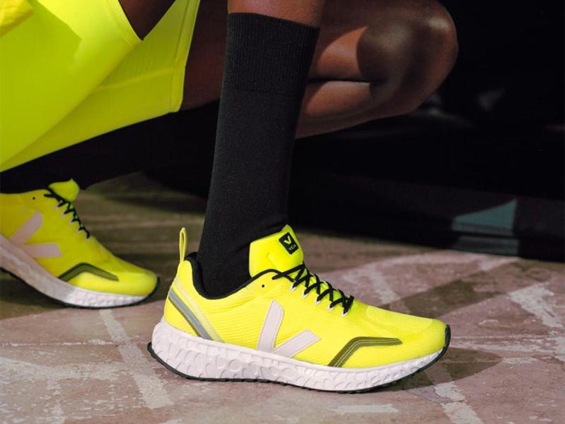 Kneeling in the Veja Condor Mesh Jaune fluorescent yellow and white shoes.