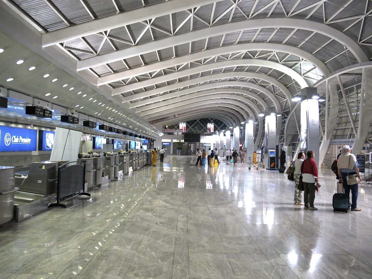 Interior of an airport lobby that's open and airy with people milling around