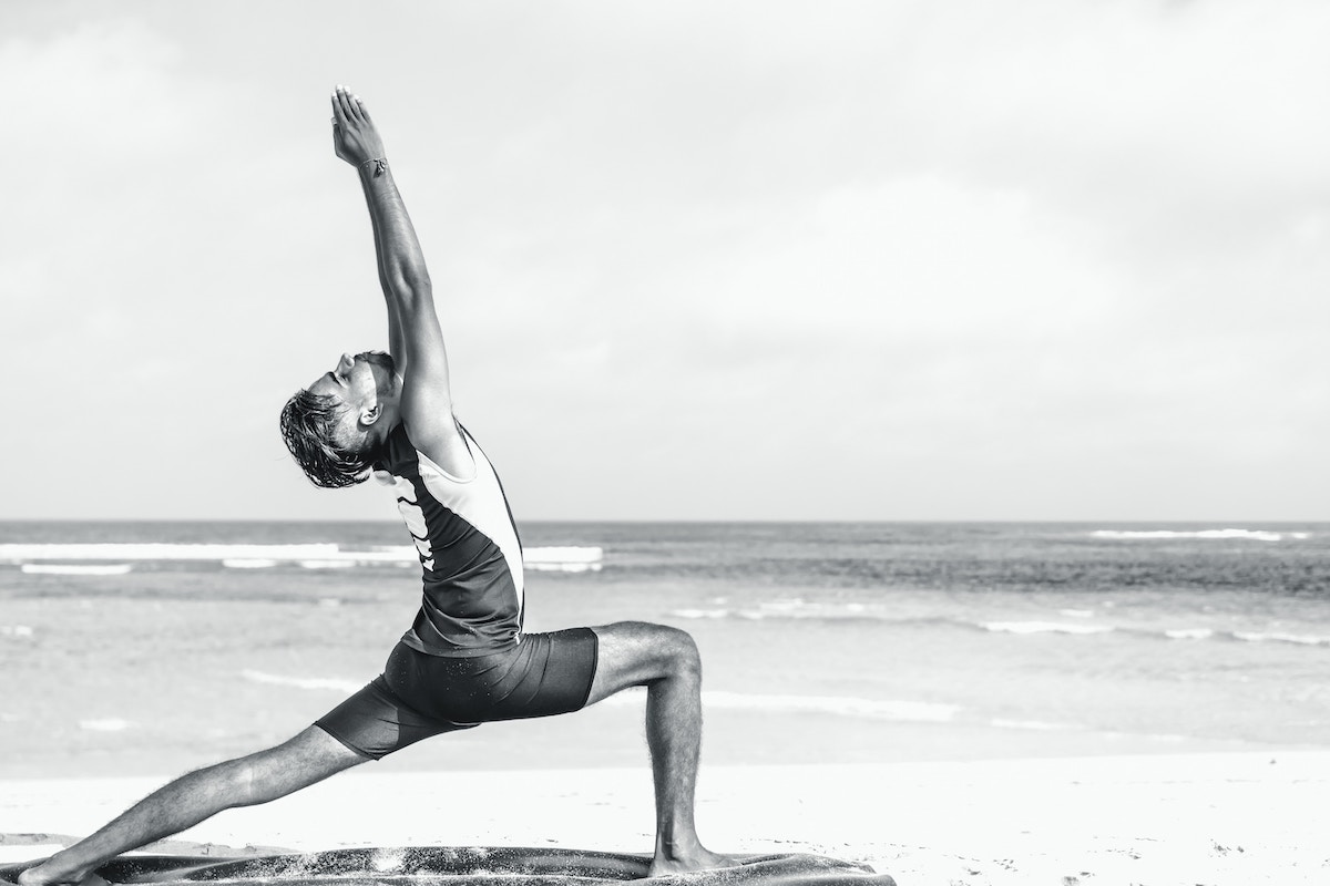 a black and white photo of a man on a beach