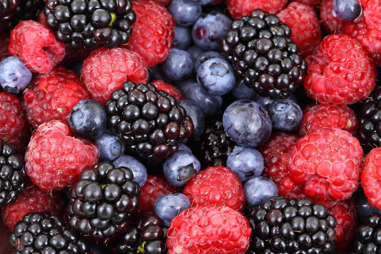 Blackberries, blueberries, and strawberries in the same container