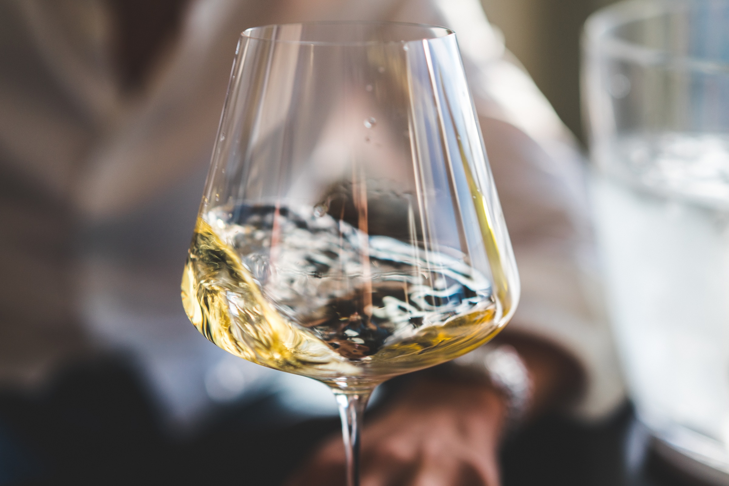 White wine in glass swirling