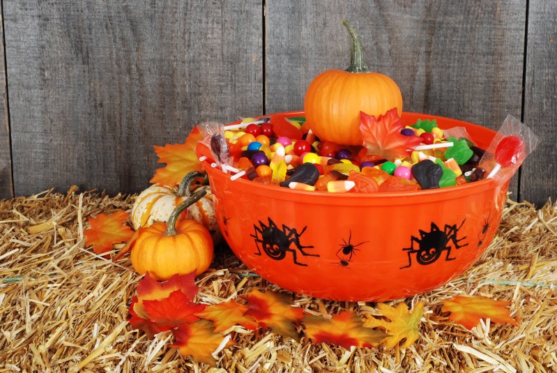 bowl of halloween candy with fall leaves