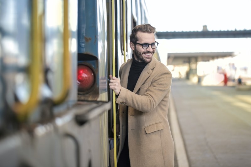 Man in cashmere coat getting on a rain