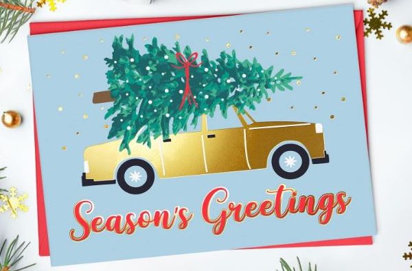 Christmas card showing a tree strapped to a car roof.