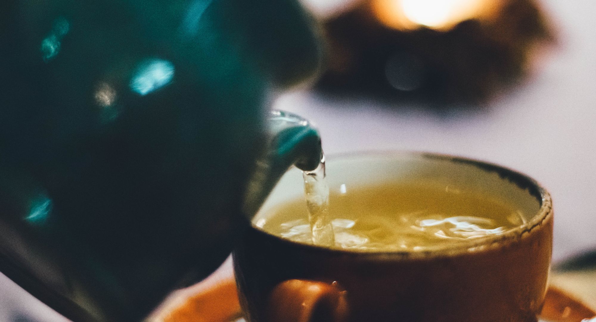 Tea kettle and a cup of green tea