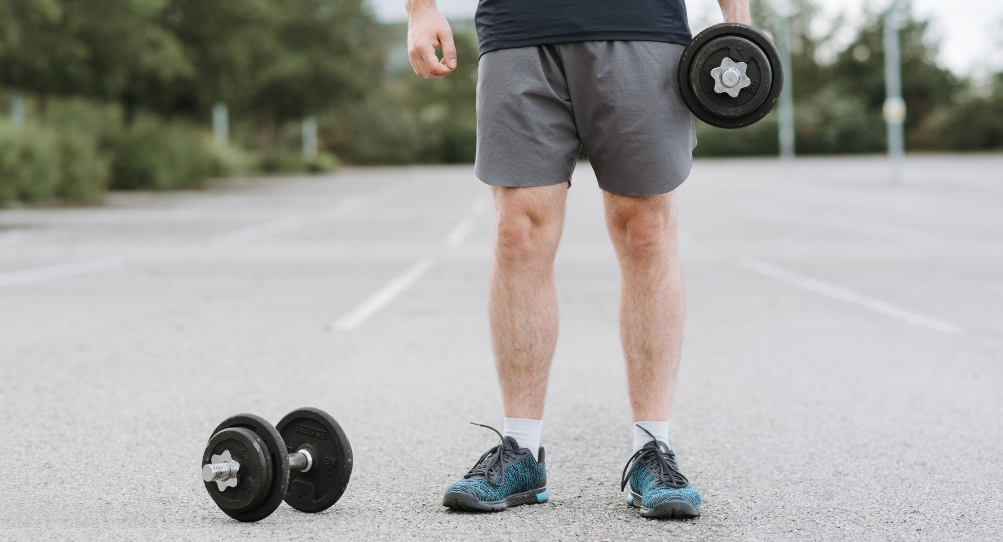 man holding weights outside