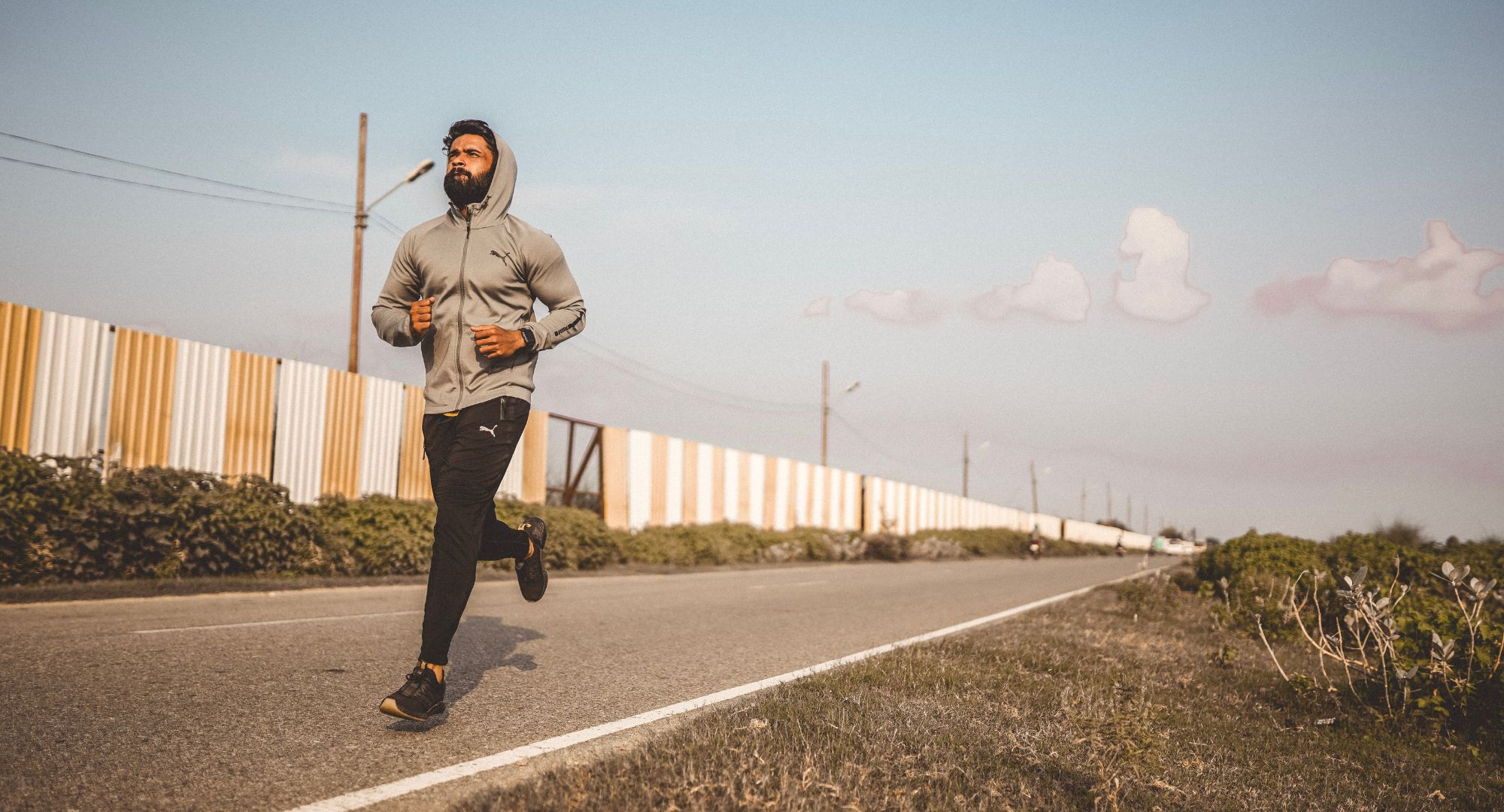 man jogging on pavement 