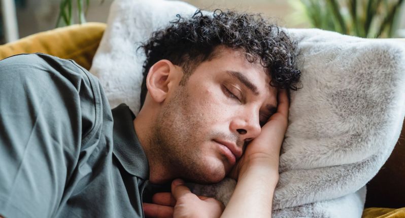 Man sleeping on soft white pillow