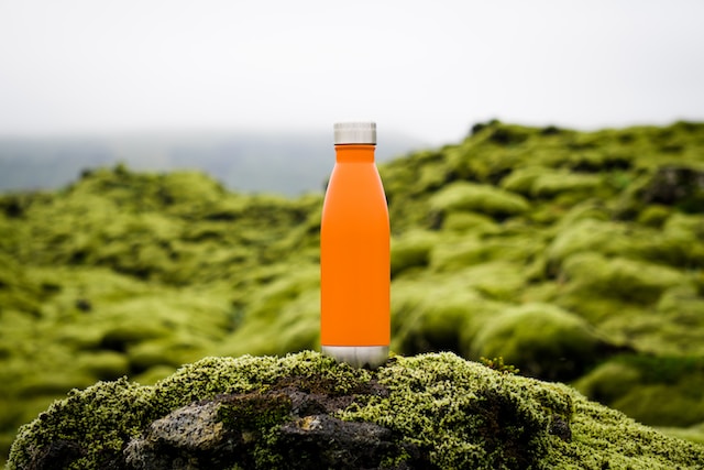 orange water bottle sitting outside