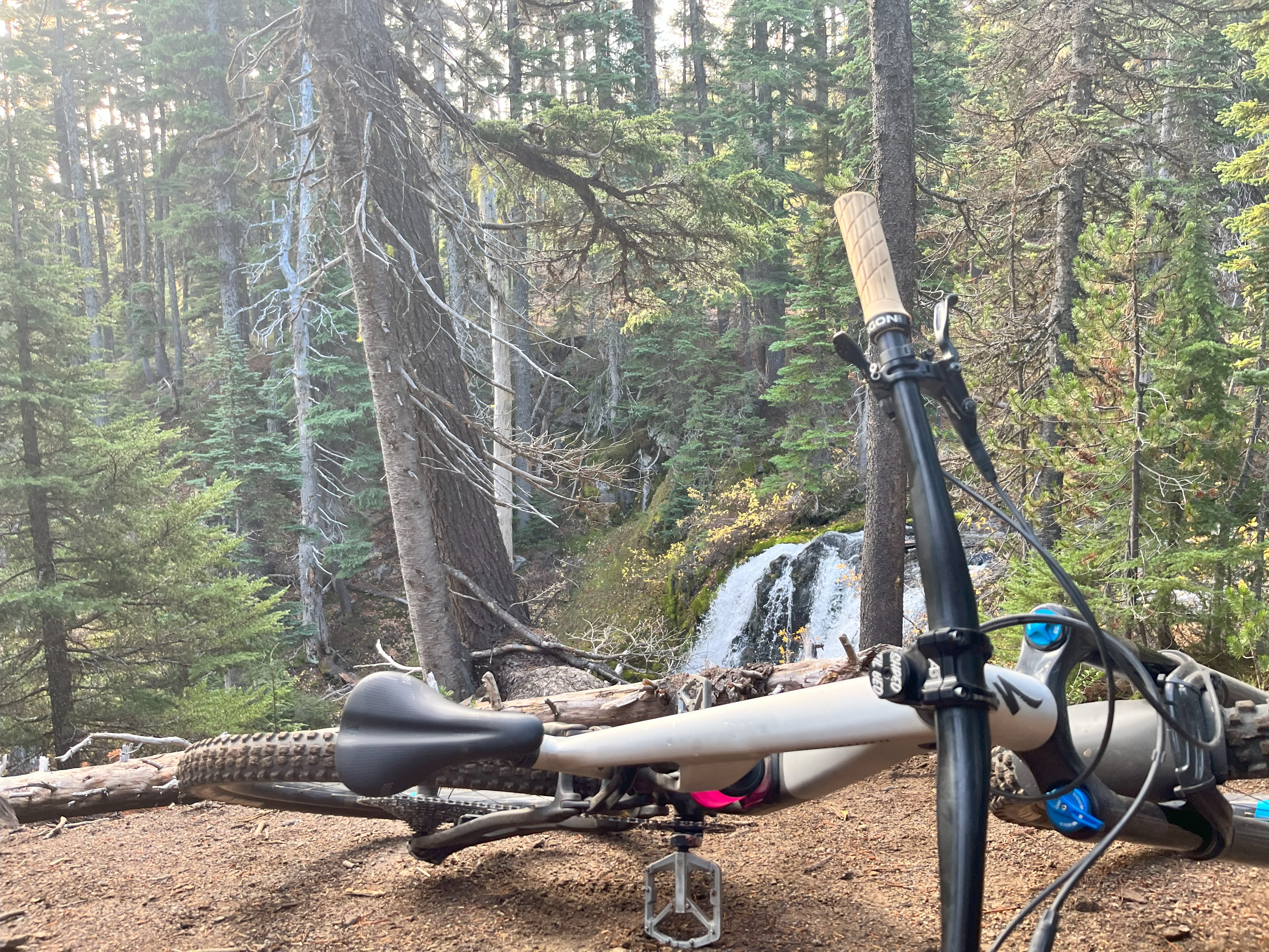 A mountain bike with a waterfall in the background