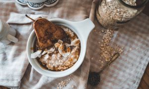a bowl of oatmeal with a grilled pear