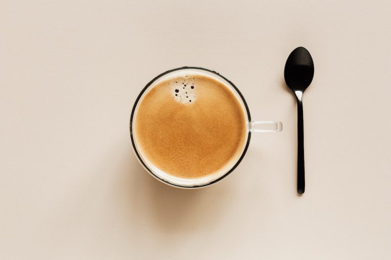 Top view of a cup of coffee with a spoon