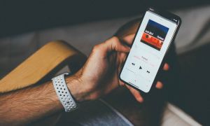 A person listening to music on their iPhone.