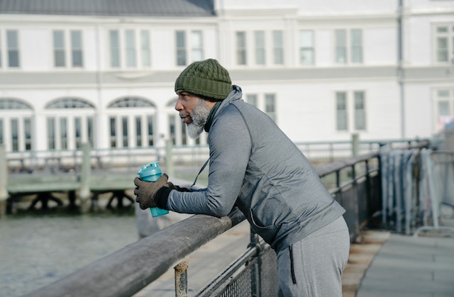 man drinking water during a run