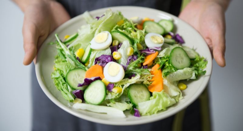 Person holding a salad
