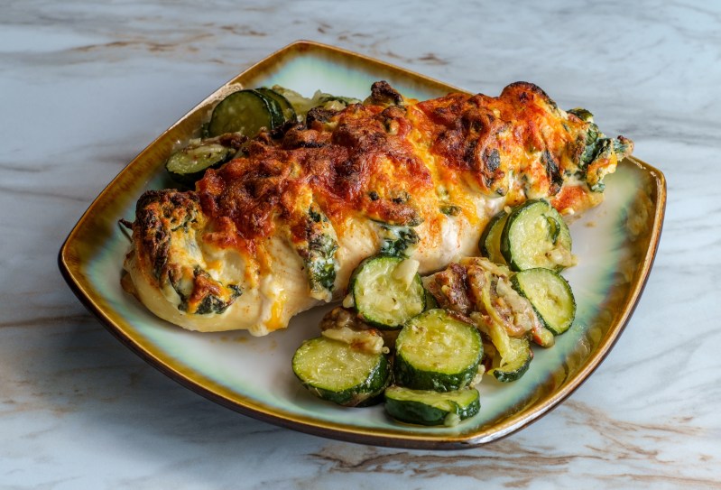 Baked roasted hasselback chicken stuffed with ricotta cheese and spinach