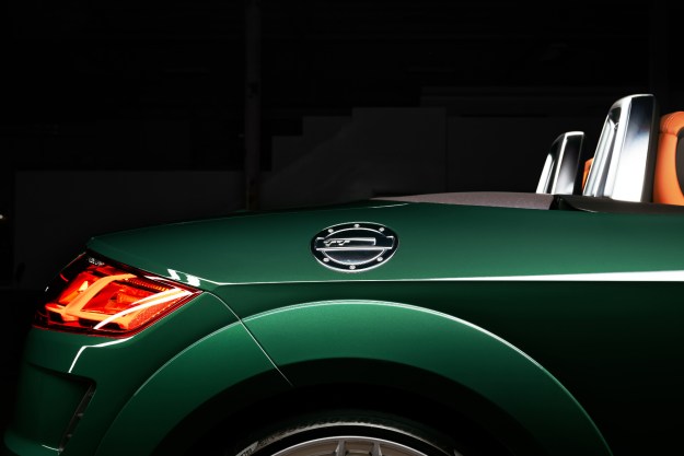 2023 Audi TT Roadster Final Edition view across the right rear quarter panel of the green car in an empty warehouse
