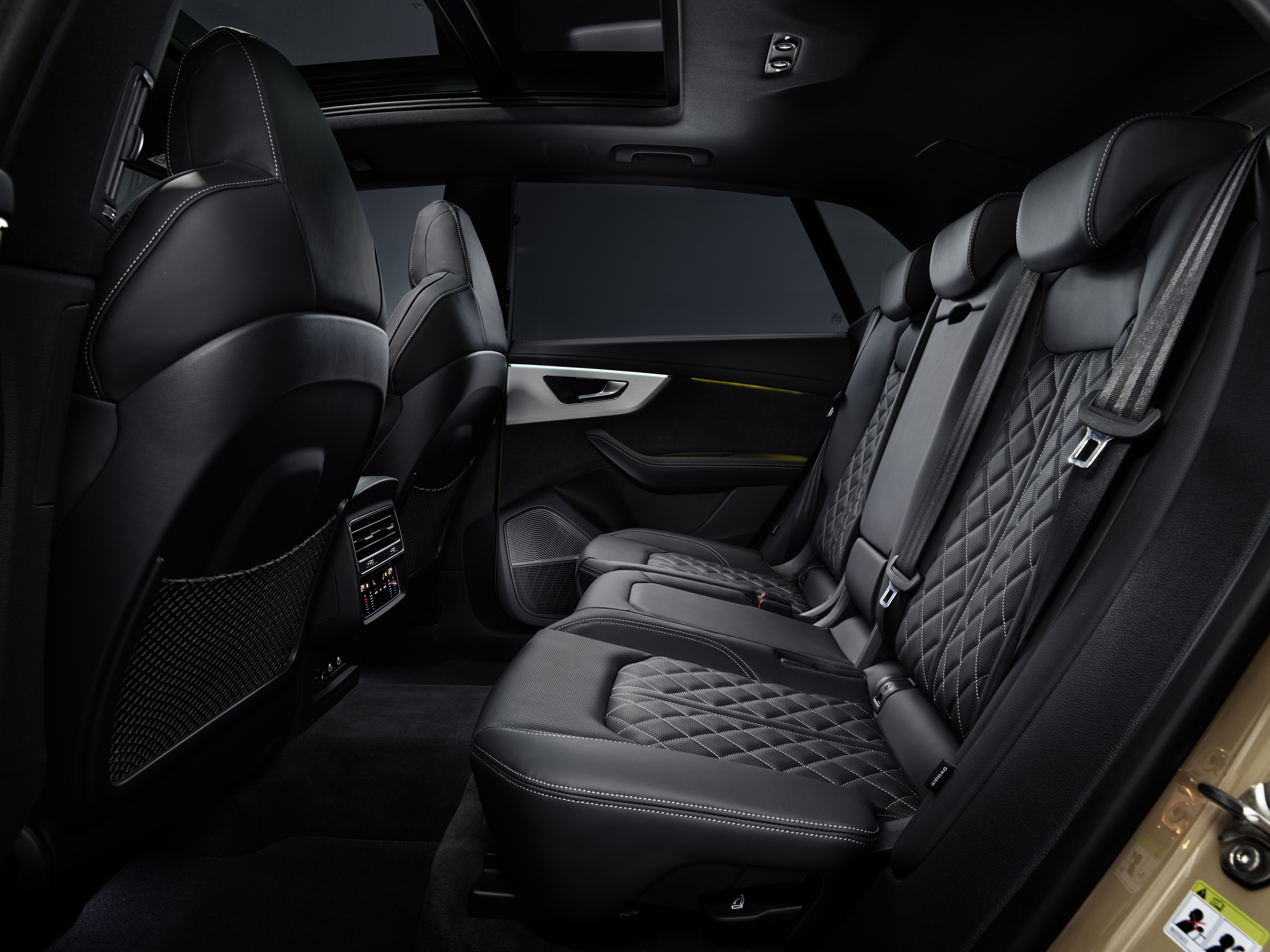 2024 Audi Q8 55 TFSI in Sakhir Gold interior back seat view from the drivers side -- European Model Shown.