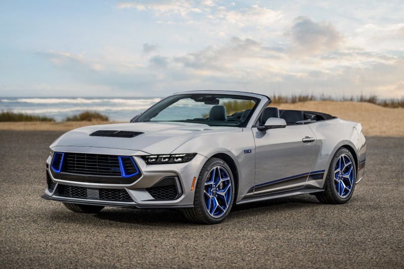 2024 Ford Mustang GT California Special convertible parked by the beach with the top down three-quarter view from the left front