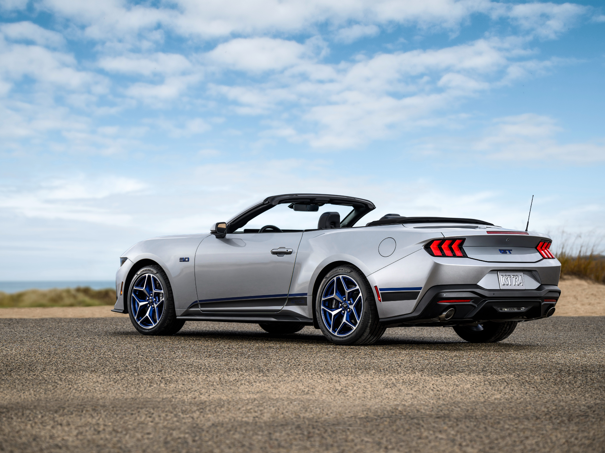 2024 Ford Mustang GT California Special convertible with the top down three-quarter view from the left.