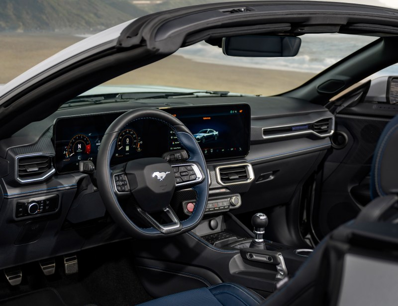2024 Ford Mustang GT California Special interior view of the front seats from the left side withthe driver's door open.