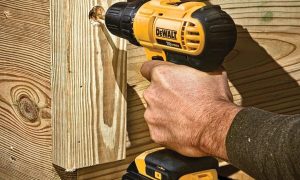 A DeWALT drill bearing into wood.