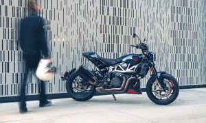 Motorcycle rider out of focus carrying helmet toward Indian Motorcycle 2024 FTR x 100% R limited edition