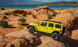 Yellow 2024 Jeep Wrangler Rubicon X4e rock climbing at a state park in Utah.