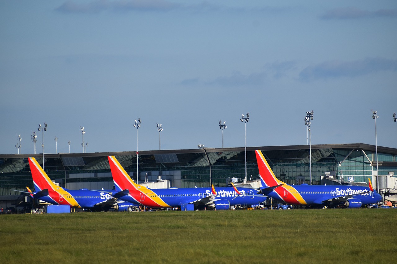 Several Southwest Airlines planes were lined up at an airport outside