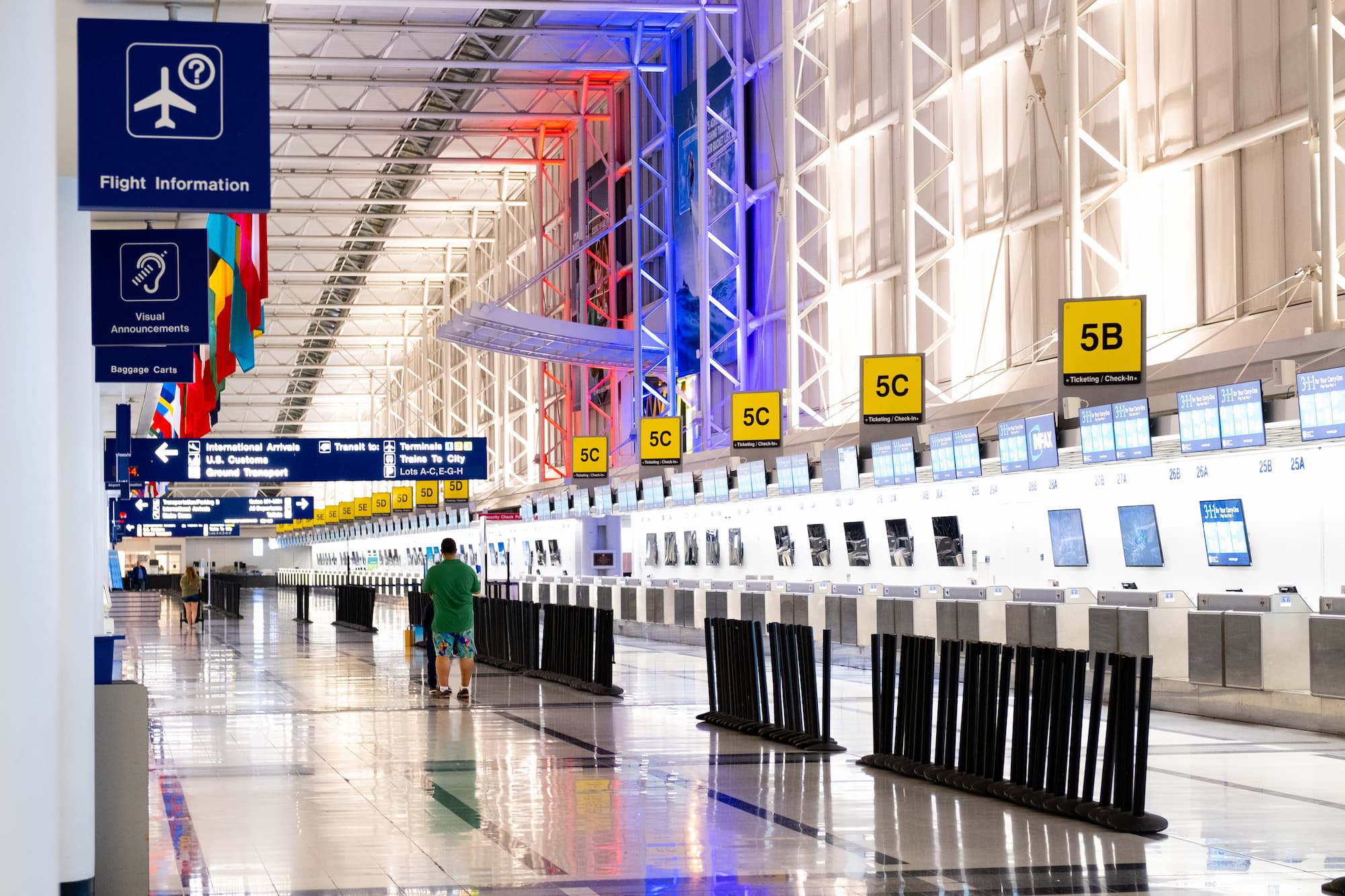 man walking through airport terminal