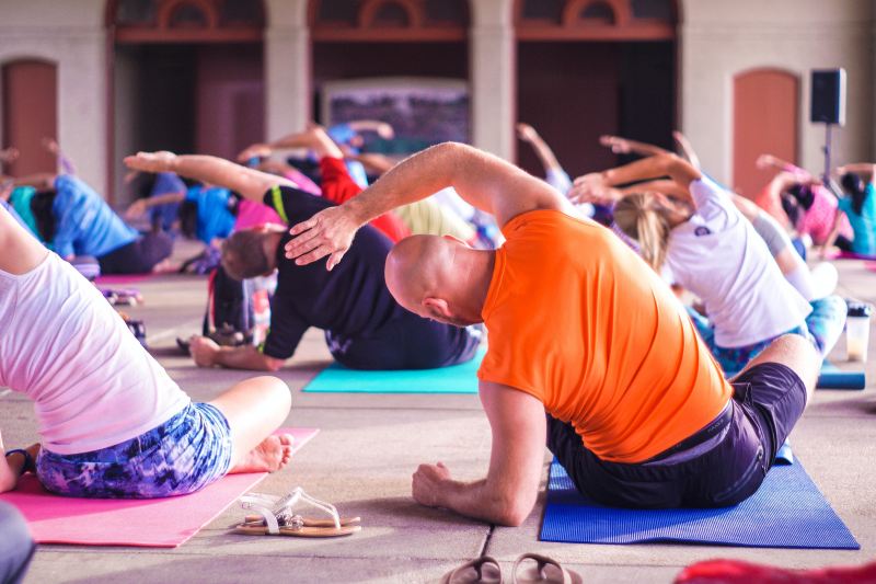 yoga class side bend seated on mats