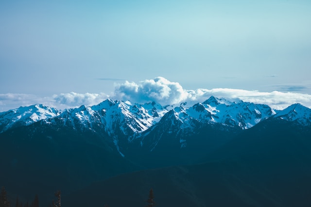 Snow capped mountains with clouds above at Mount Olympic National Park