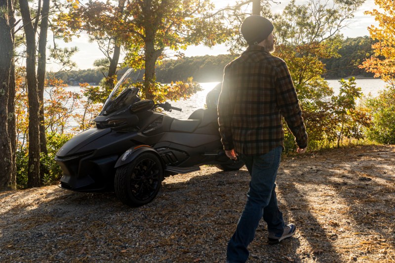 Man walking in front of a CAN-AM Spyder RT Limited three-wheeler.