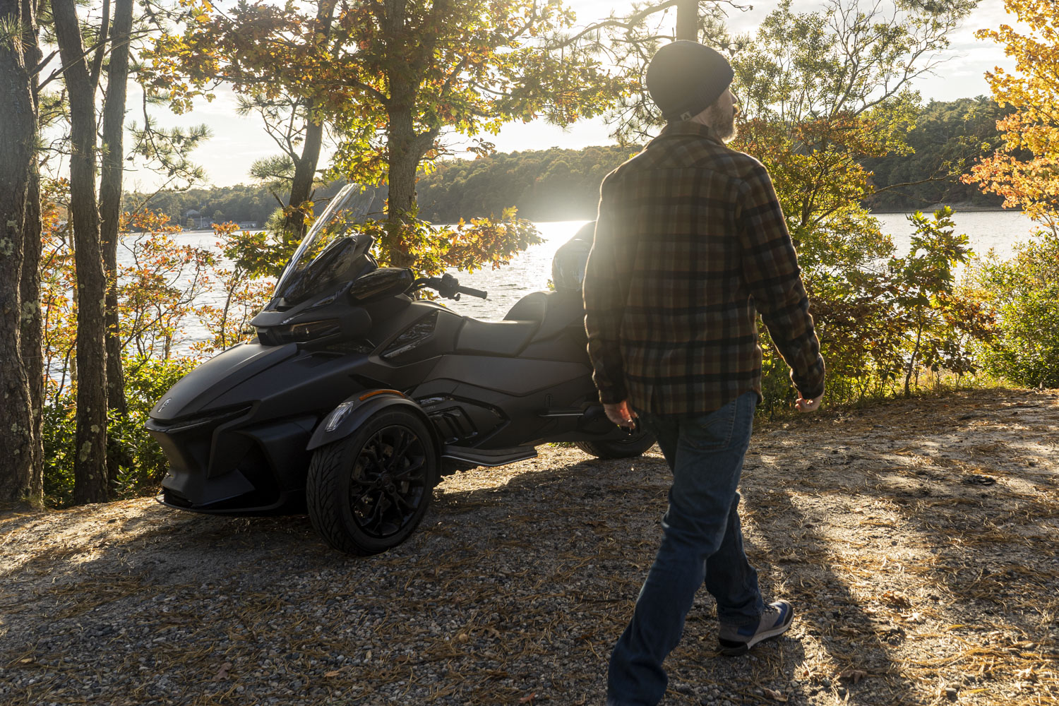 Man walking in front of a CAN-AM Spyder RT Limited three-wheeler.