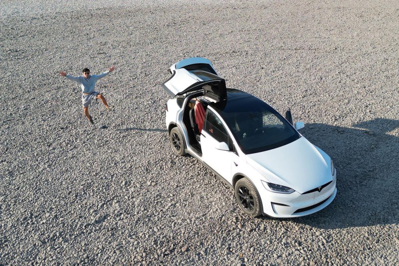 Aerial shot of YouTuber Everyday Sandro outside his Tesla Model X.