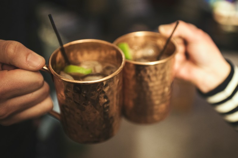 Hands toasting with moscow mules