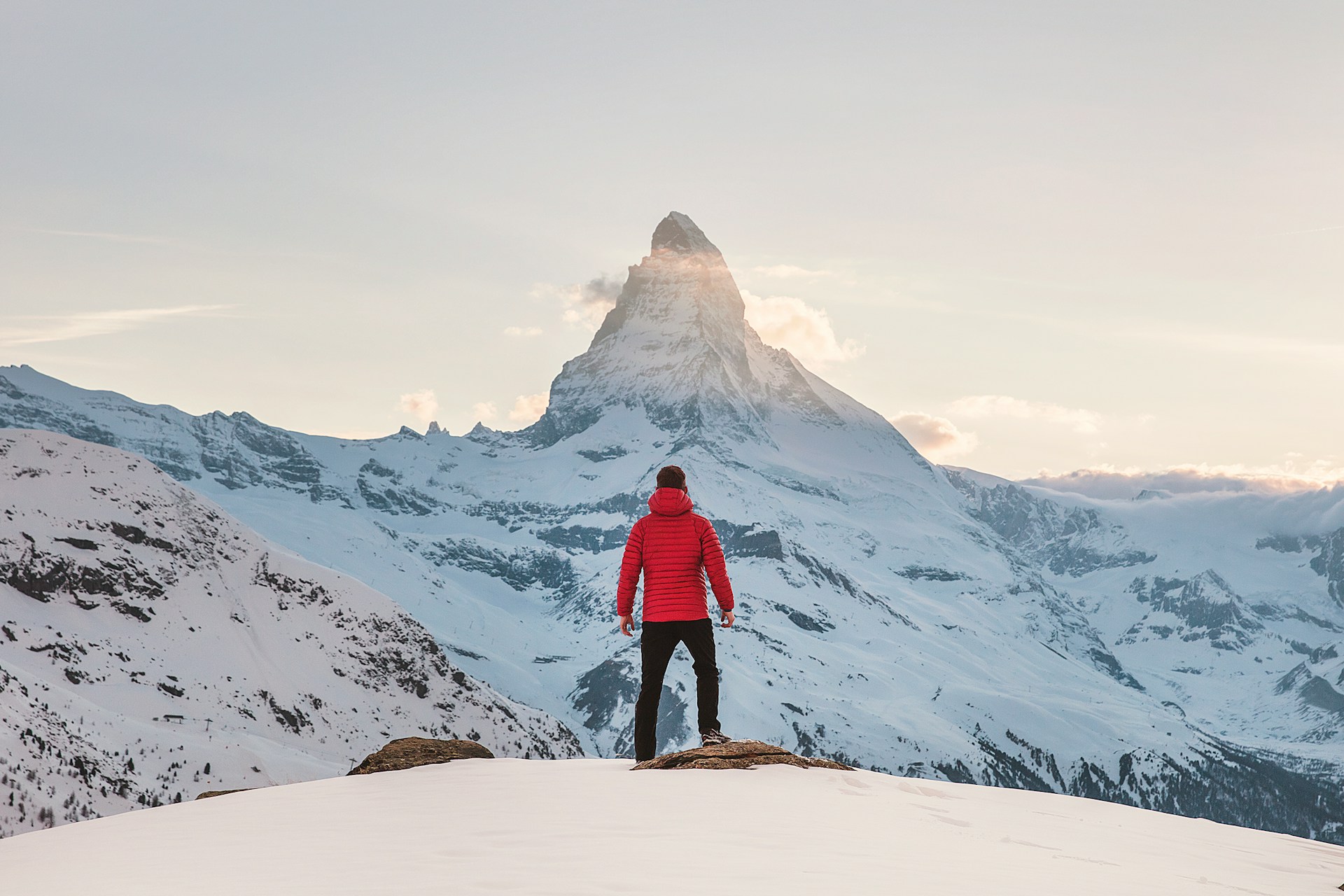 Man standing in front of snowy mountains