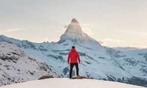 Man standing in front of snowy mountains